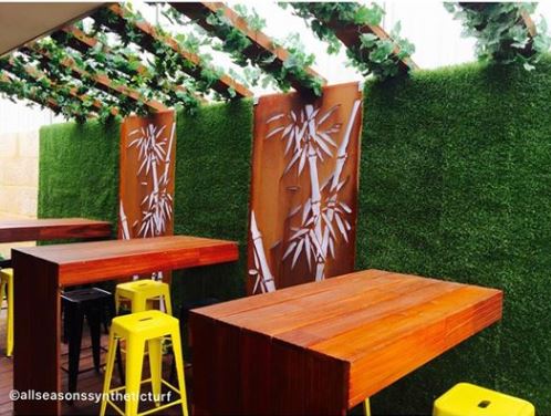 Beer garden with a synthetic turf feature wall
