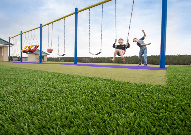 image of children playing on a swing set