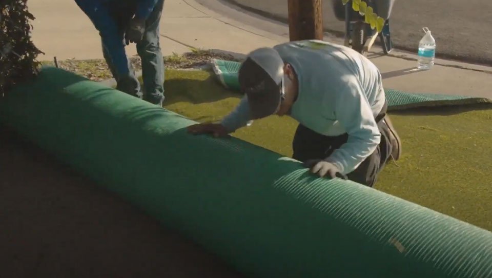image of a man installing synlawn turf