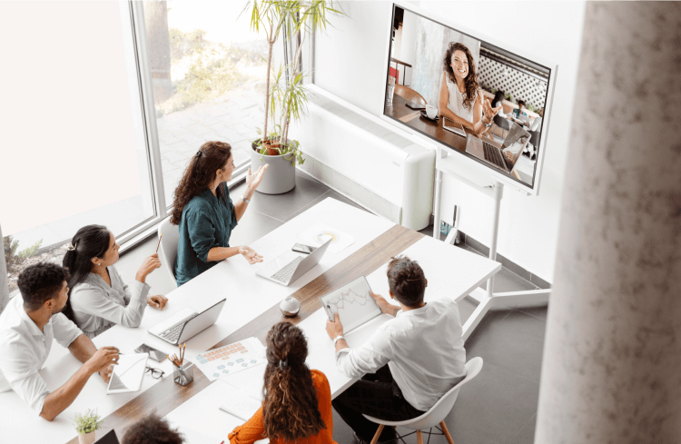 image of people at a conference table having a video meeting